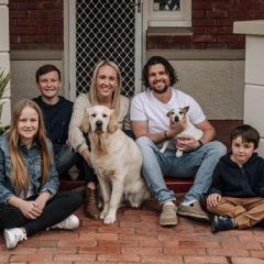 MPA Patient Story - Josh Galpin with family group seated in front of house with 2 dogs